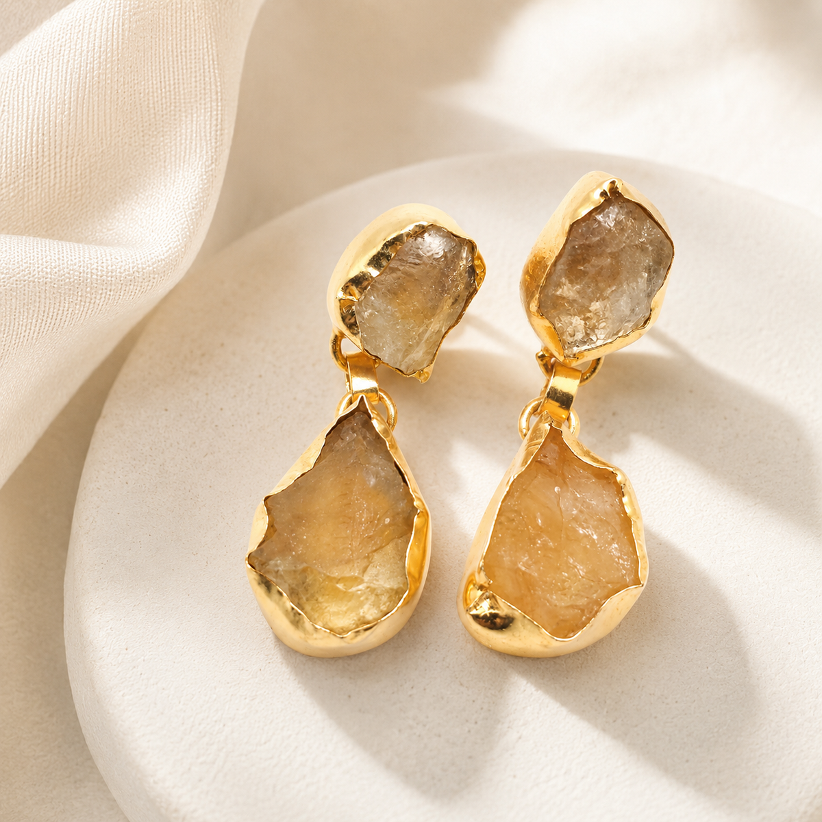 Pair of gold-plated rough citrine-like drop earrings with an organic shape.