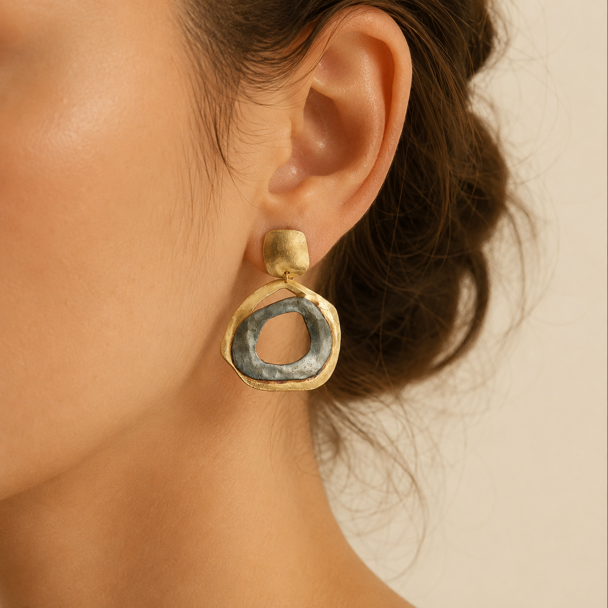 Pair of abstract circle drop earrings shown front on with a textured finish.