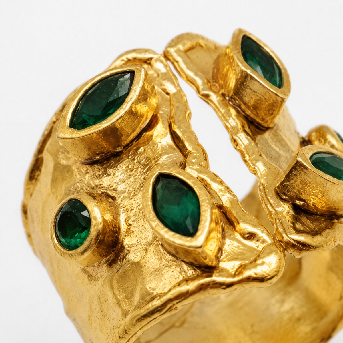 Close view of the open cuff ring with green stone accents