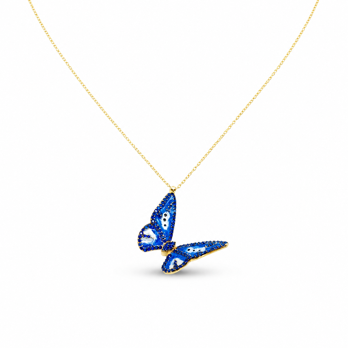 Gold-tone necklace with a blue butterfly pendant on a white background.