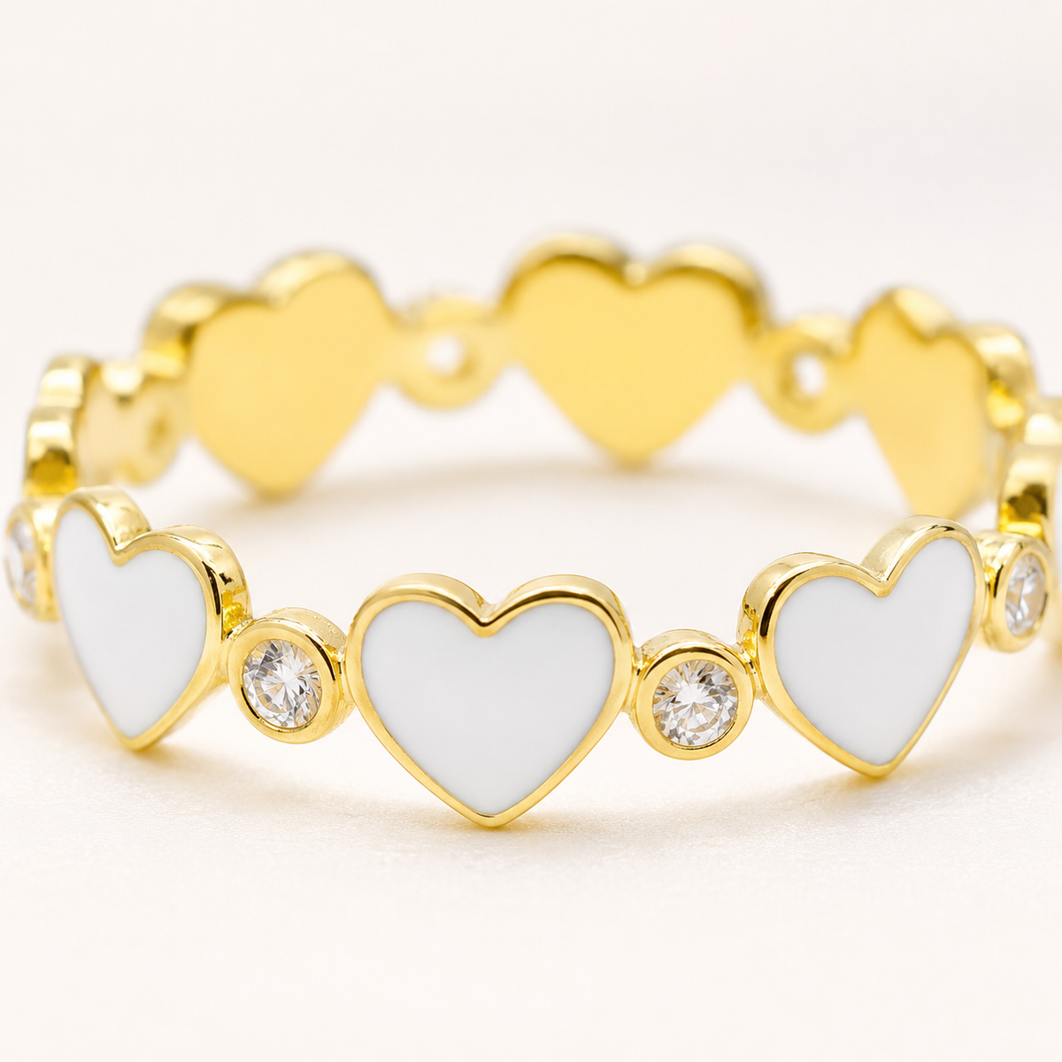 Close view of the white heart and clear stone details on the ring.