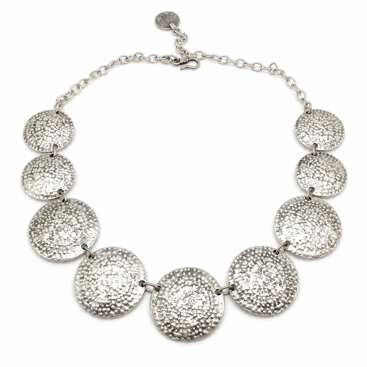 A hammered disc statement necklace with a polished silver-tone finish.