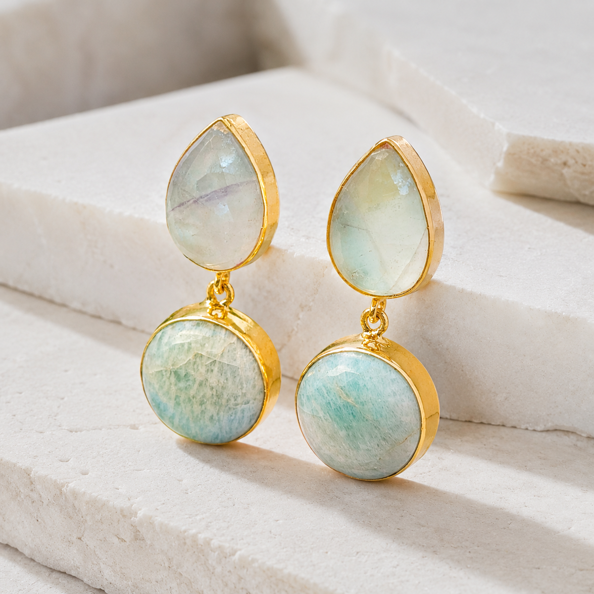 Front view of two-stone drop earrings with a polished gold-plated frame.