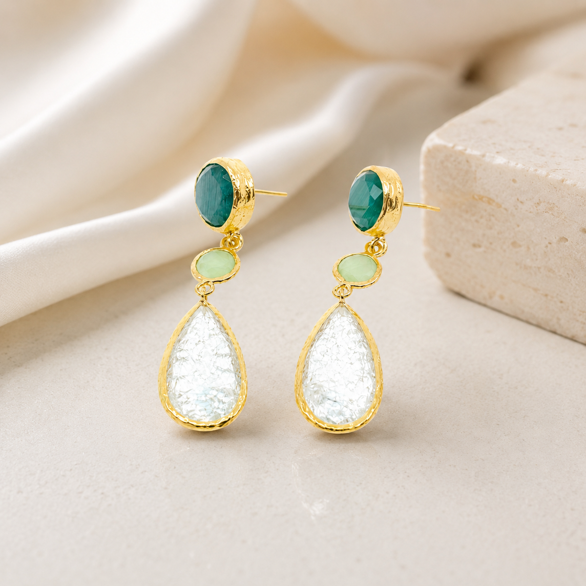 Gold-plated drop earrings with layered green and clear stones.