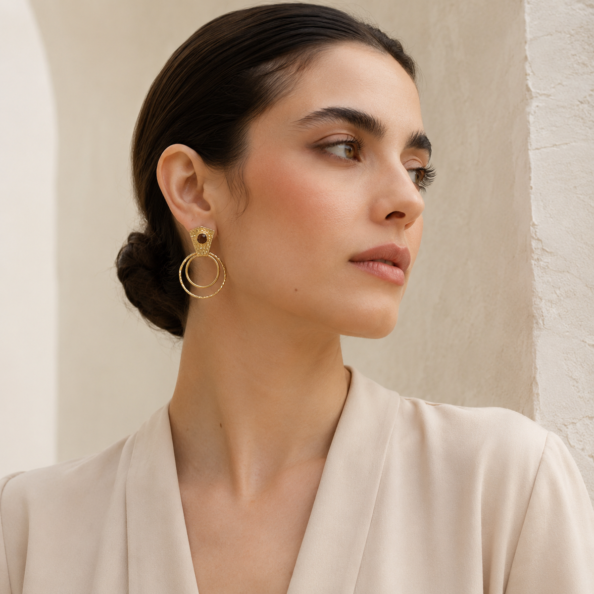 Gold-plated drop earrings with a textured finish and circular silhouette.