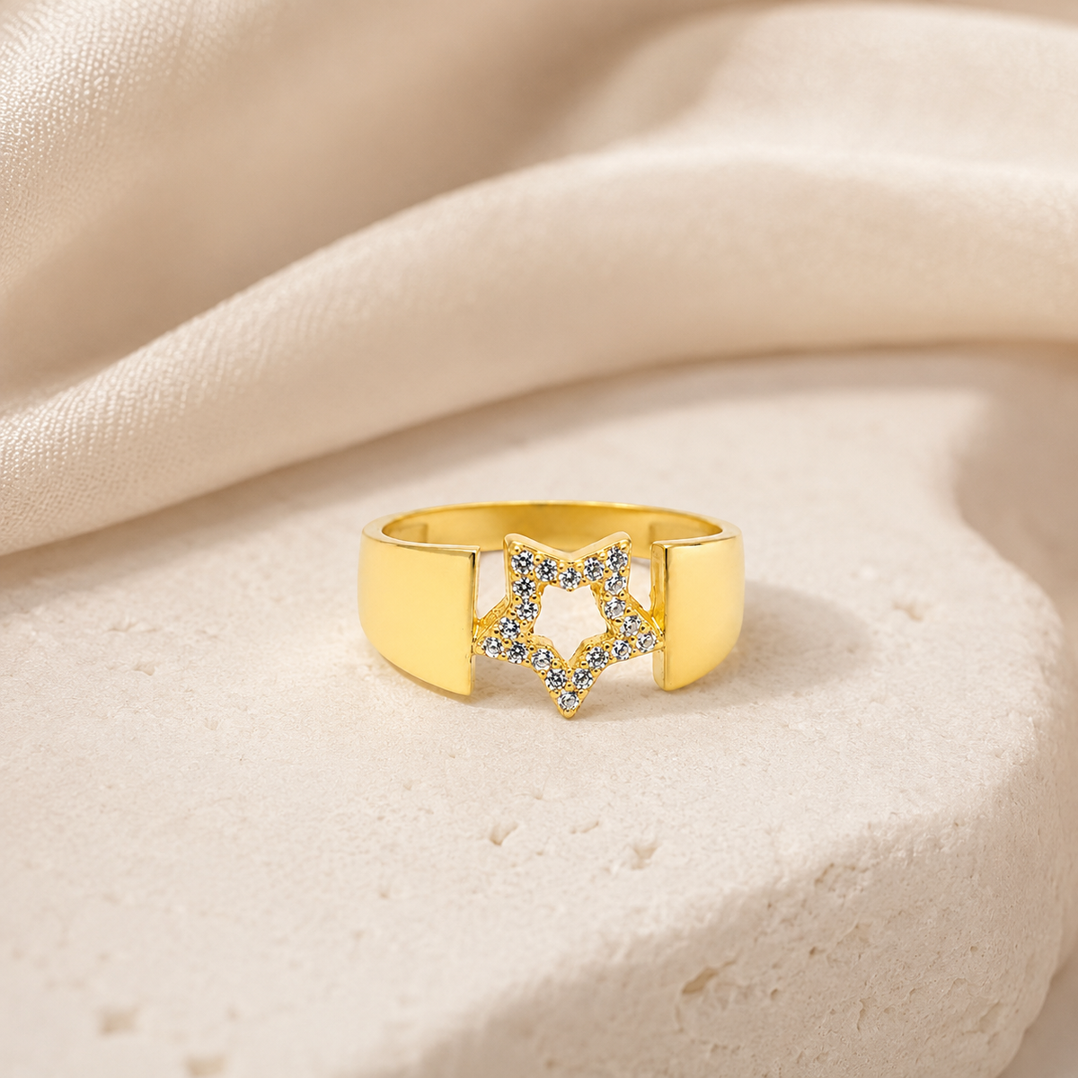 Gold-tone statement ring with a star-shaped center detail.