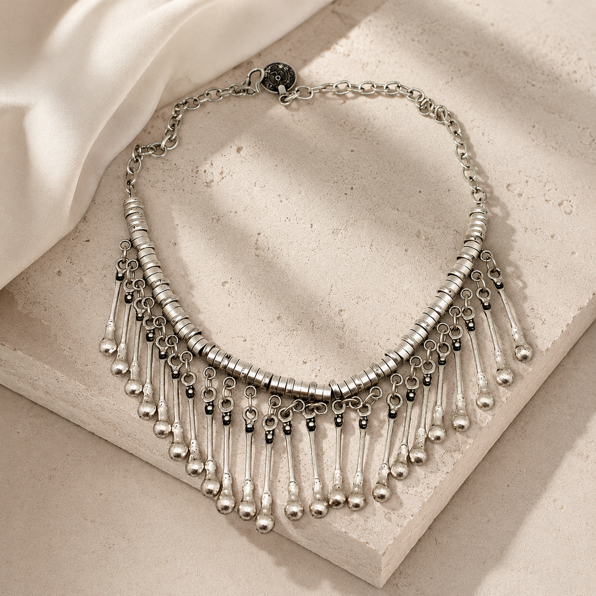 Silver-tone collar necklace with dangling fringe styling.