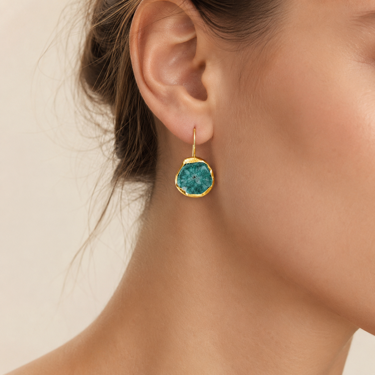 Gold-plated drop earrings with brown druzy mother of pearl centers shown from the front.
