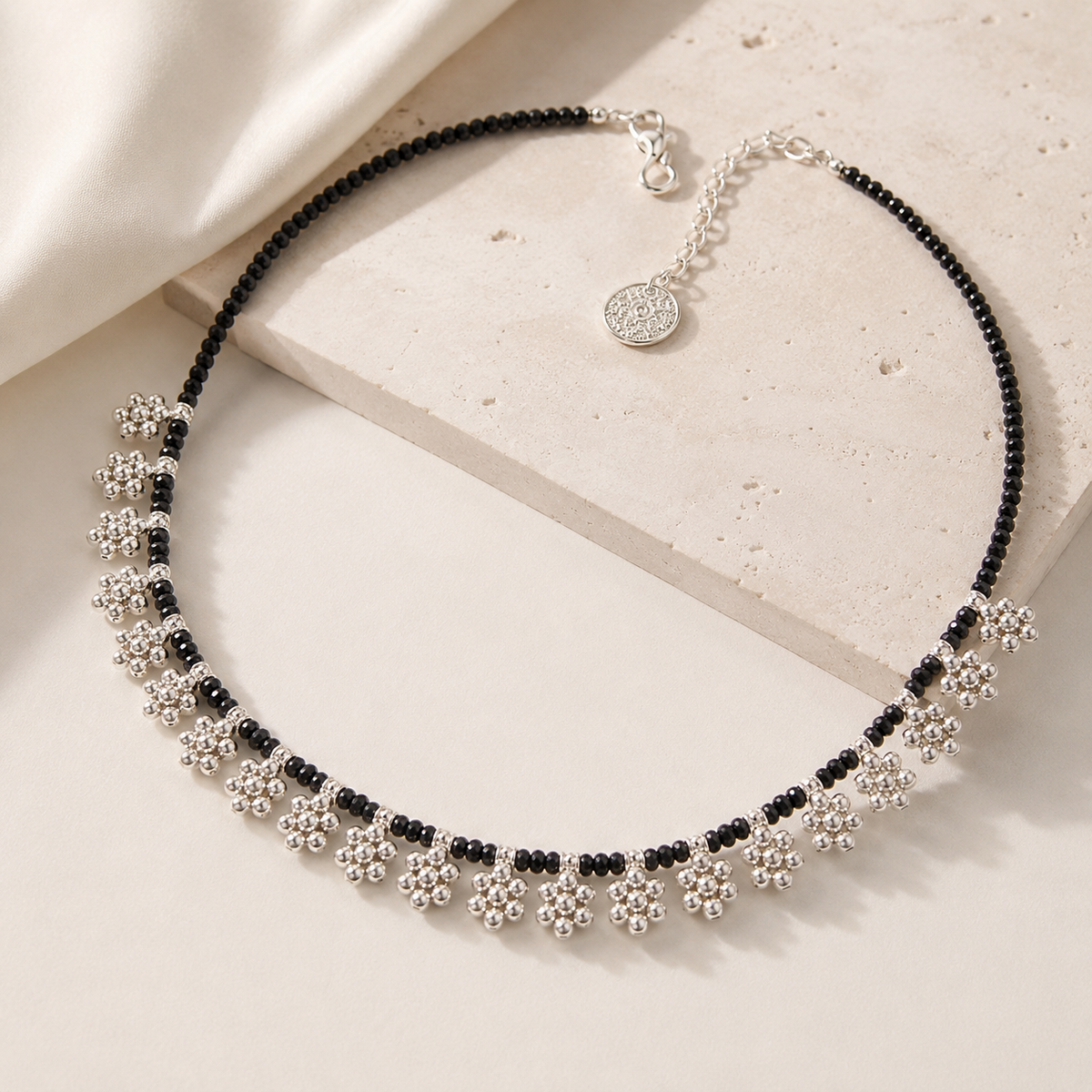 Black bead floral fringe necklace with a delicate statement silhouette.