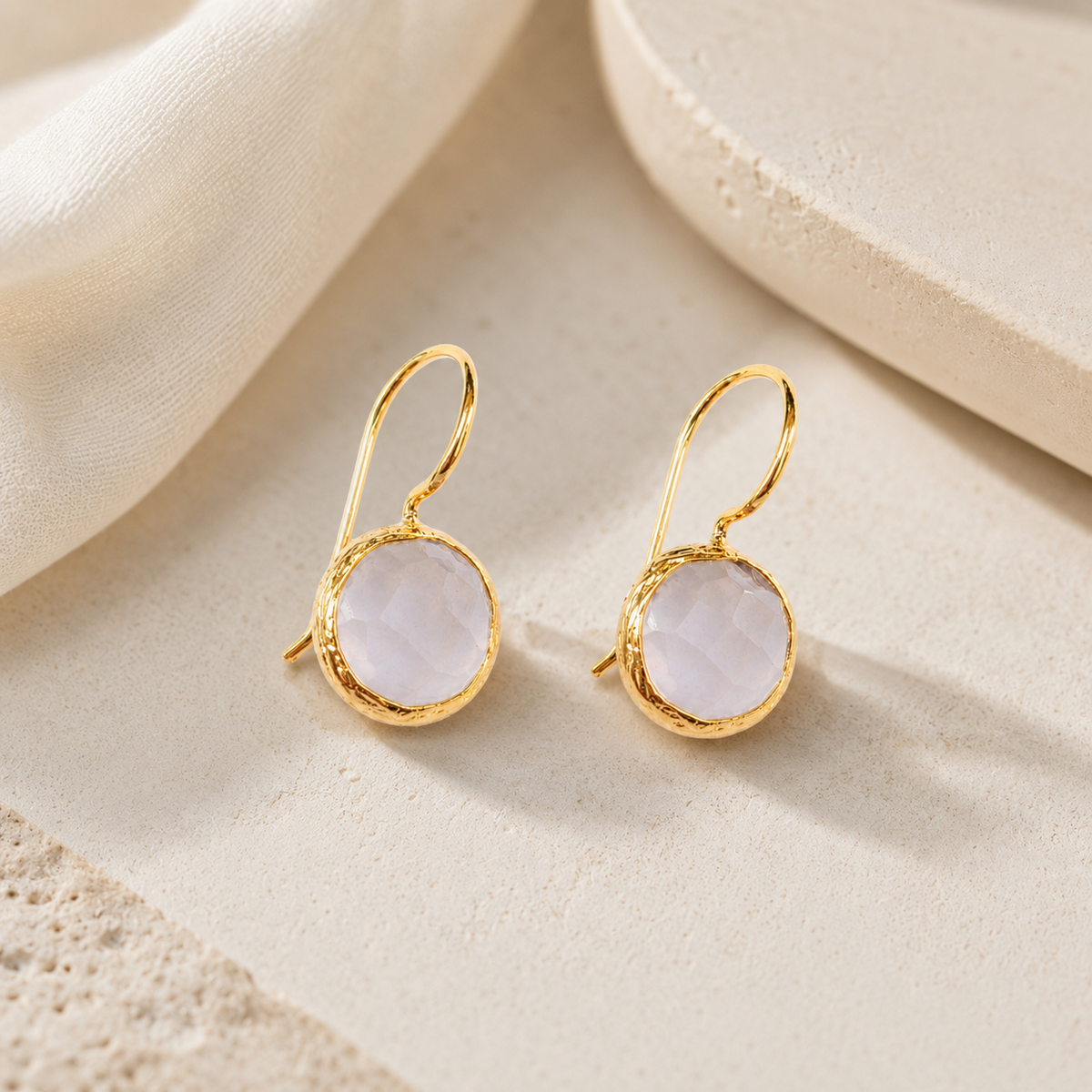 Moonstone drop earrings with a soft pale stone and gold-plated finish.