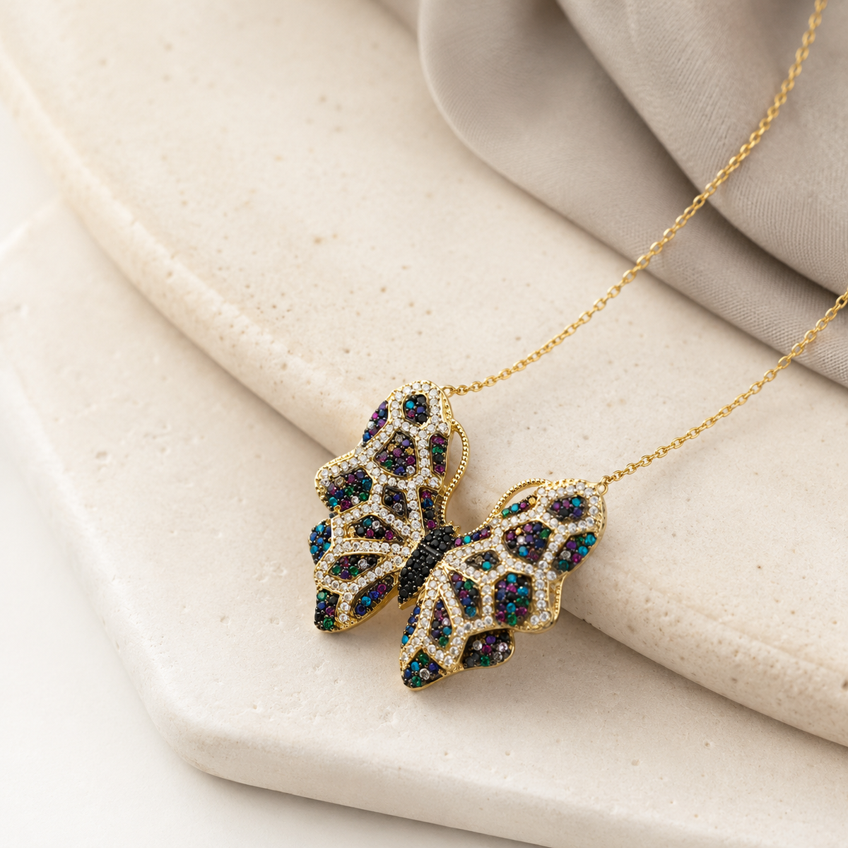 Angled view of a butterfly pendant necklace with multicolor CZ accents.
