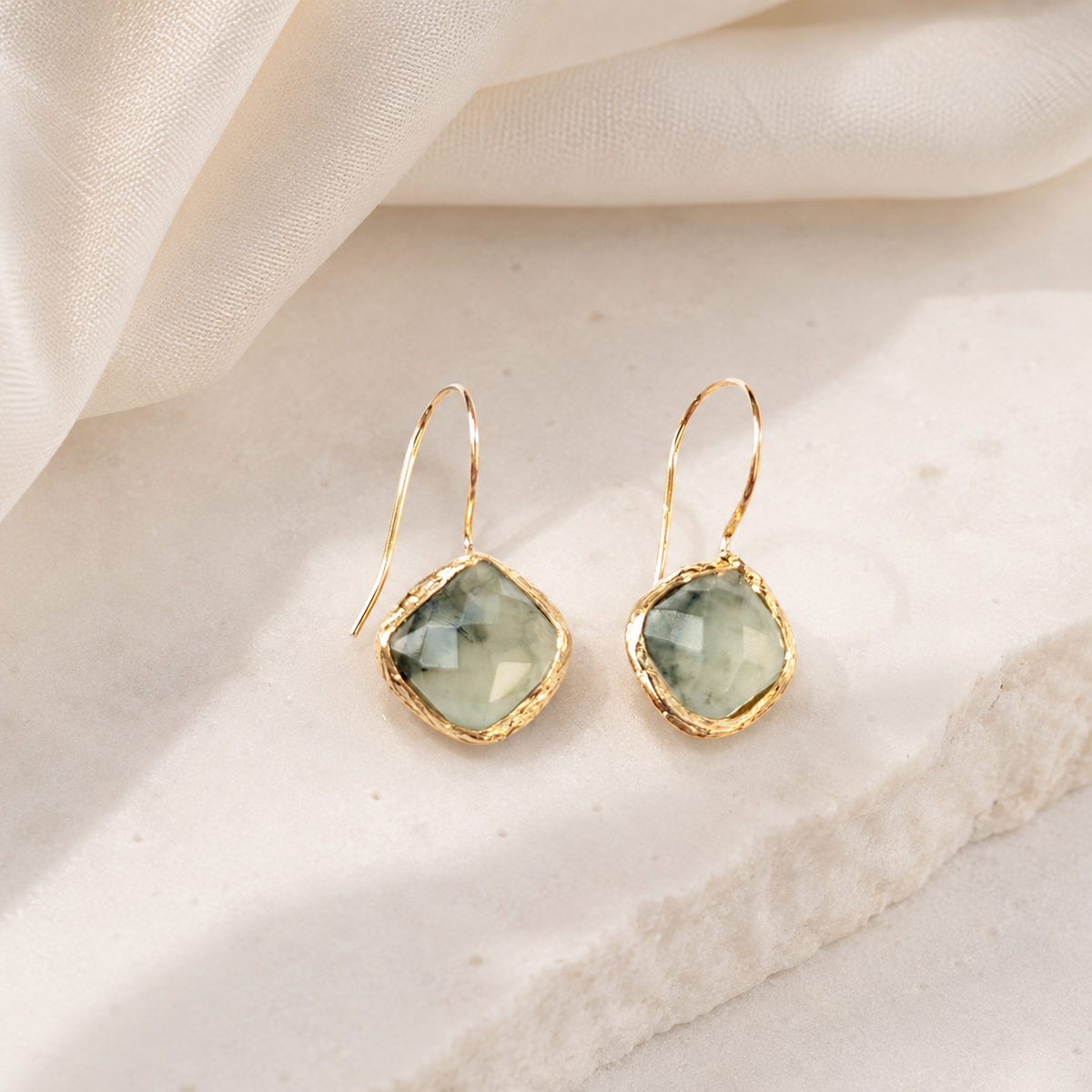 Green aventurine drop earrings with a gold-plated finish displayed on a white background.
