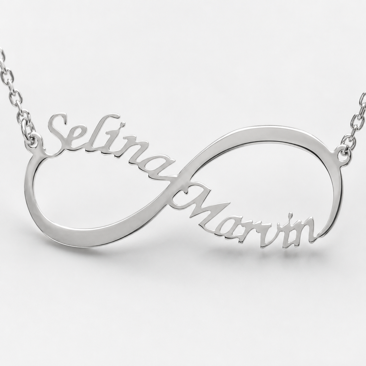 Detailed look at the engraved name and open infinity shape.