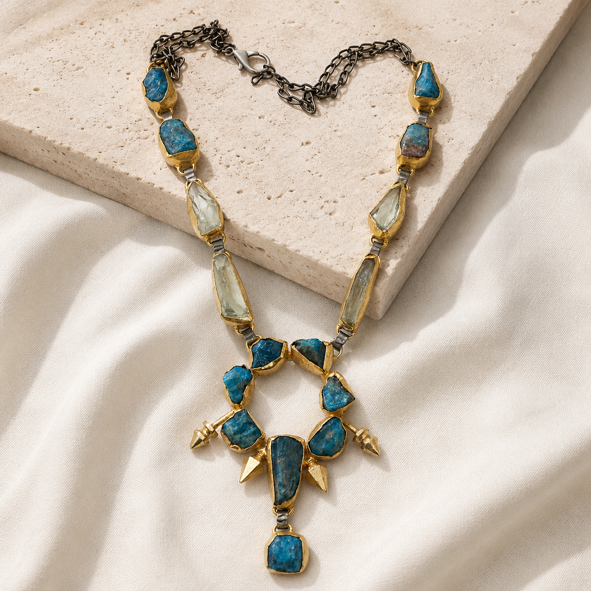 Teal raw stone pendant necklace with a bold layered shape.