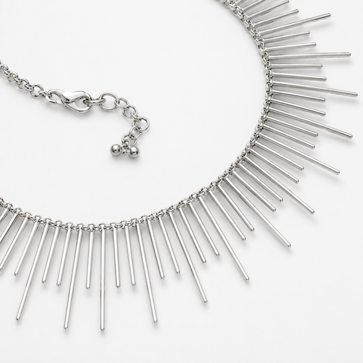 Close view of the silver-tone spike necklace and clasp detail.