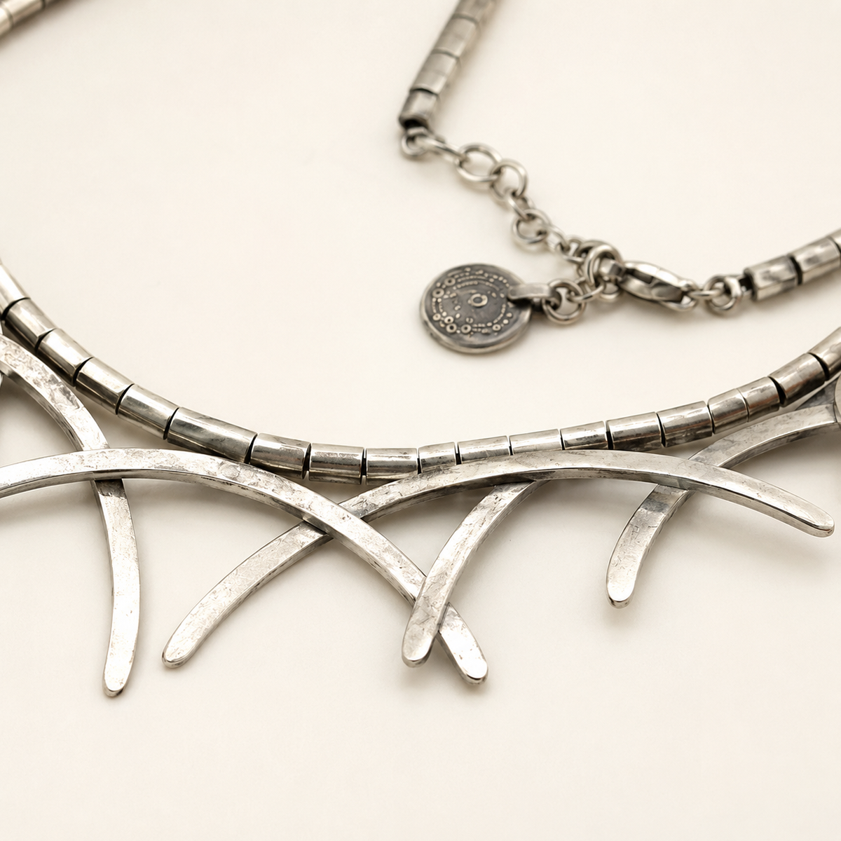 Close view of the silver-tone branch details and segmented chain.