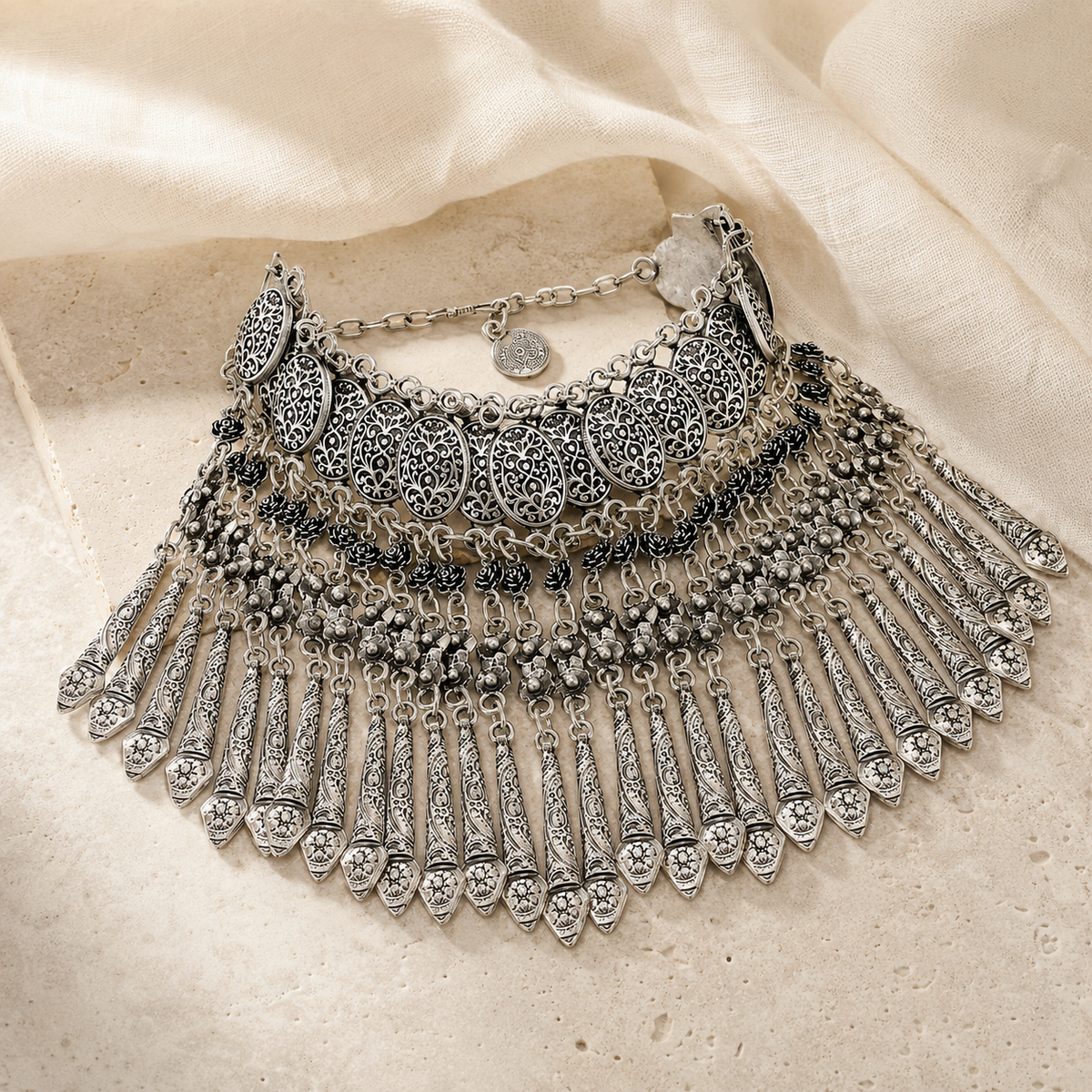 Silver-tone boho statement necklace with layered coin fringe styling.