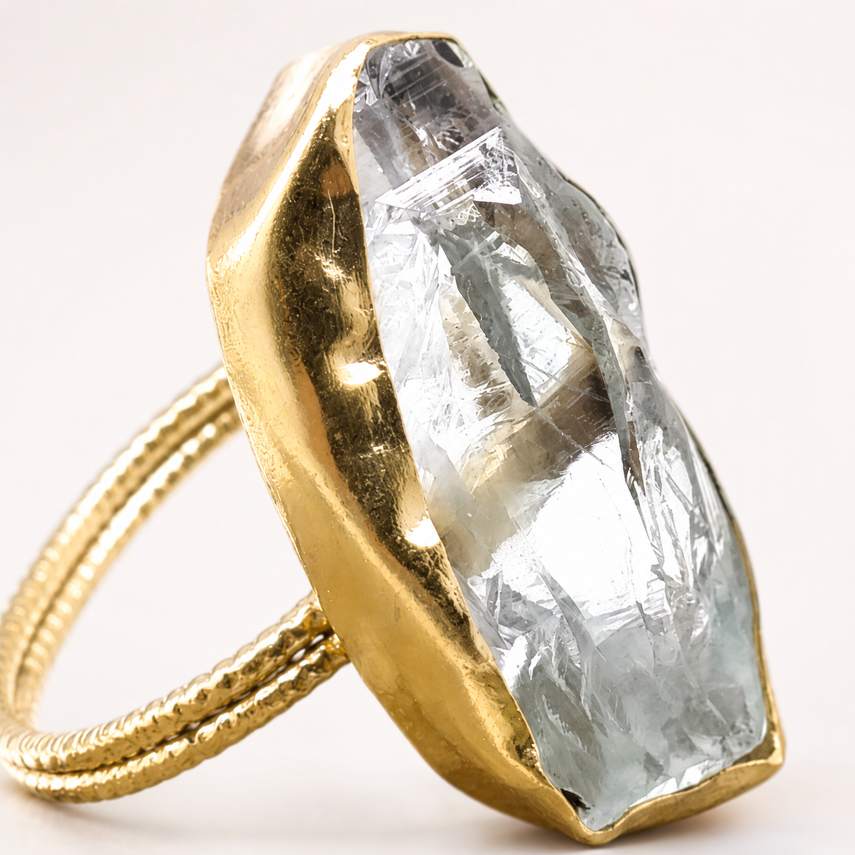 Close view of the raw crystal quartz and gold-plated ring setting.