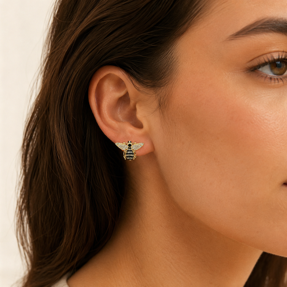 Pair of bee-shaped stud earrings with black CZ accents and a gold-plated finish.