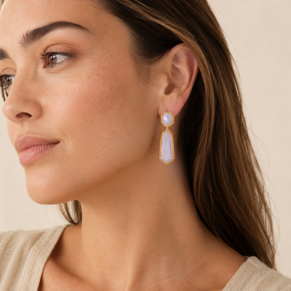 Lavender drop earrings with a gold-tone pave frame shown on a white background.