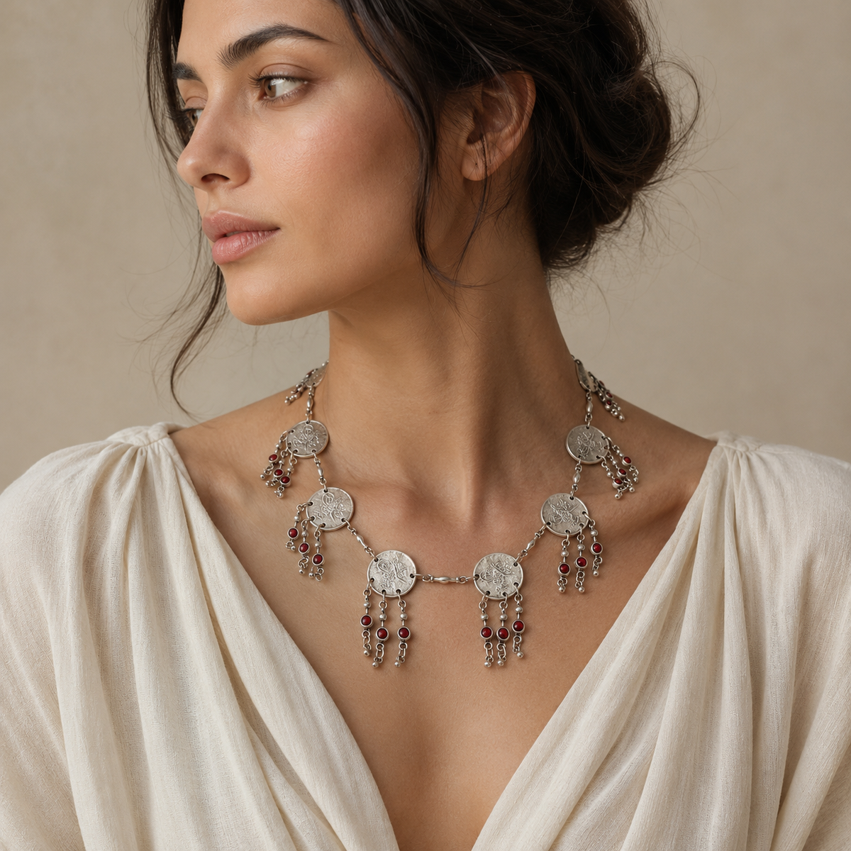 Statement necklace with silver-tone coin discs and red bead accents.