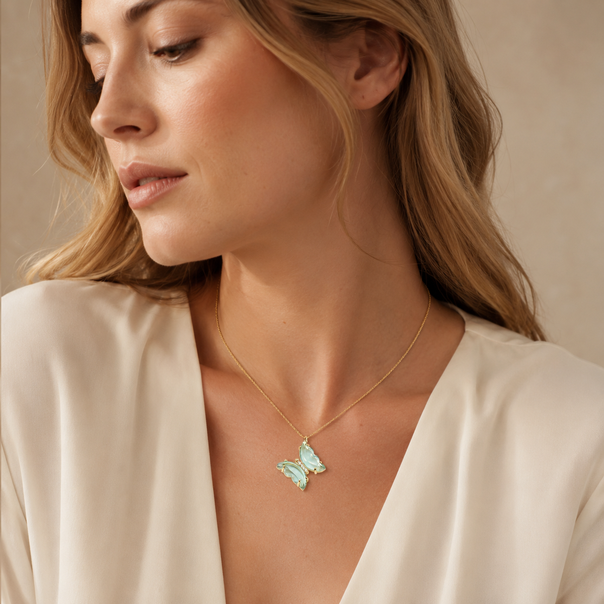 Butterfly pendant necklace in light blue with a gold-tone finish.