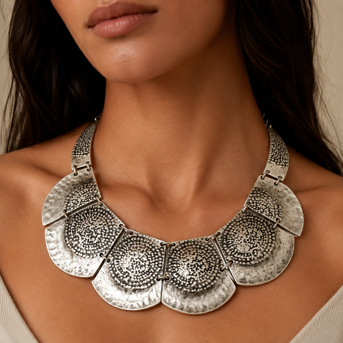 Silver hammered plate statement necklace shown on a white background.