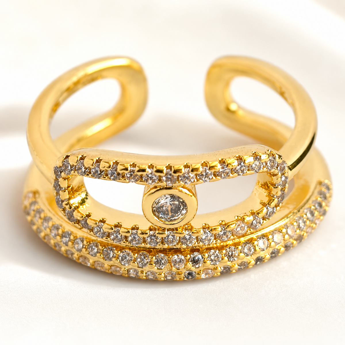 Close view of a gold-tone wrap ring with CZ accents across the front.