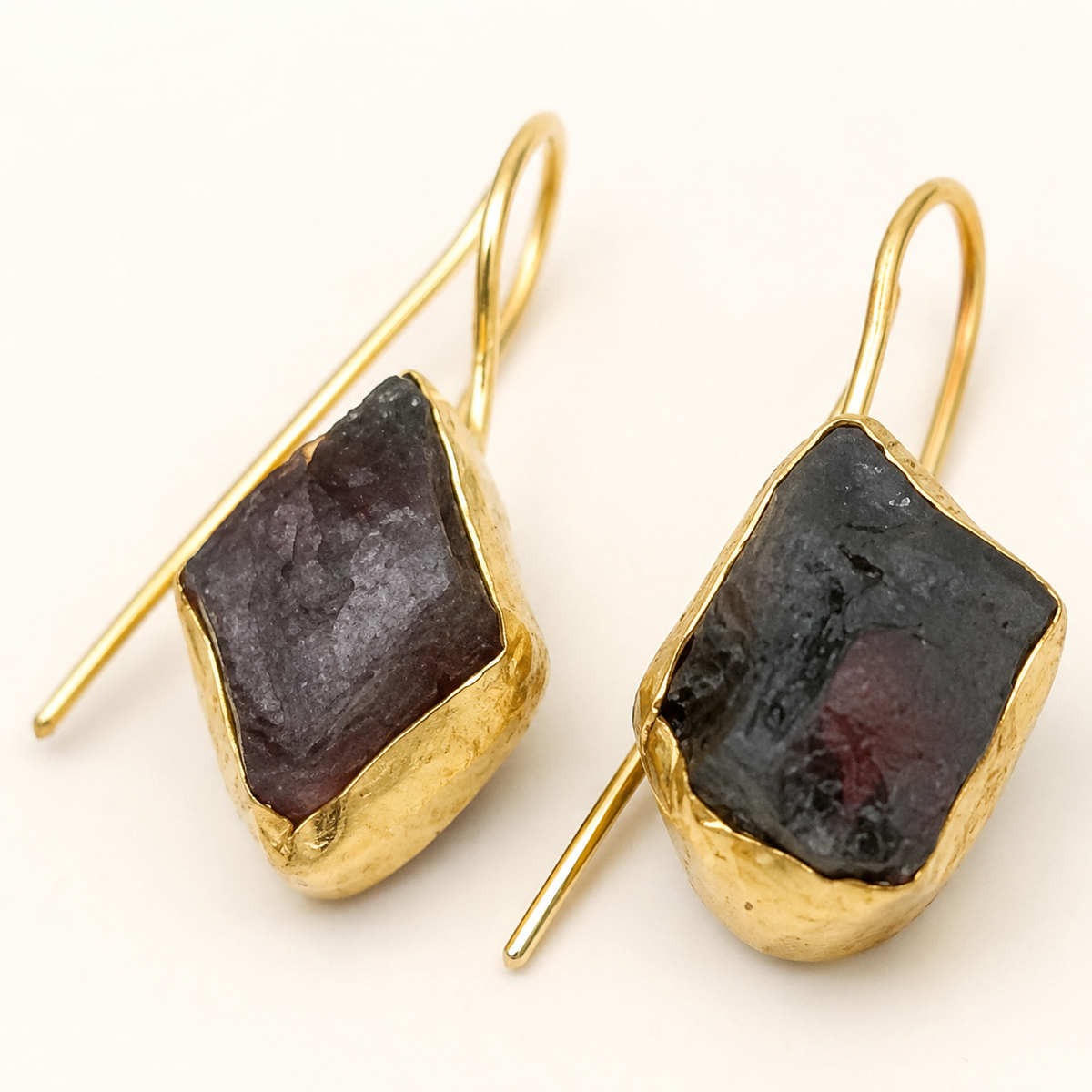Close view of green agate slice drop earrings with a polished gold-plated finish.