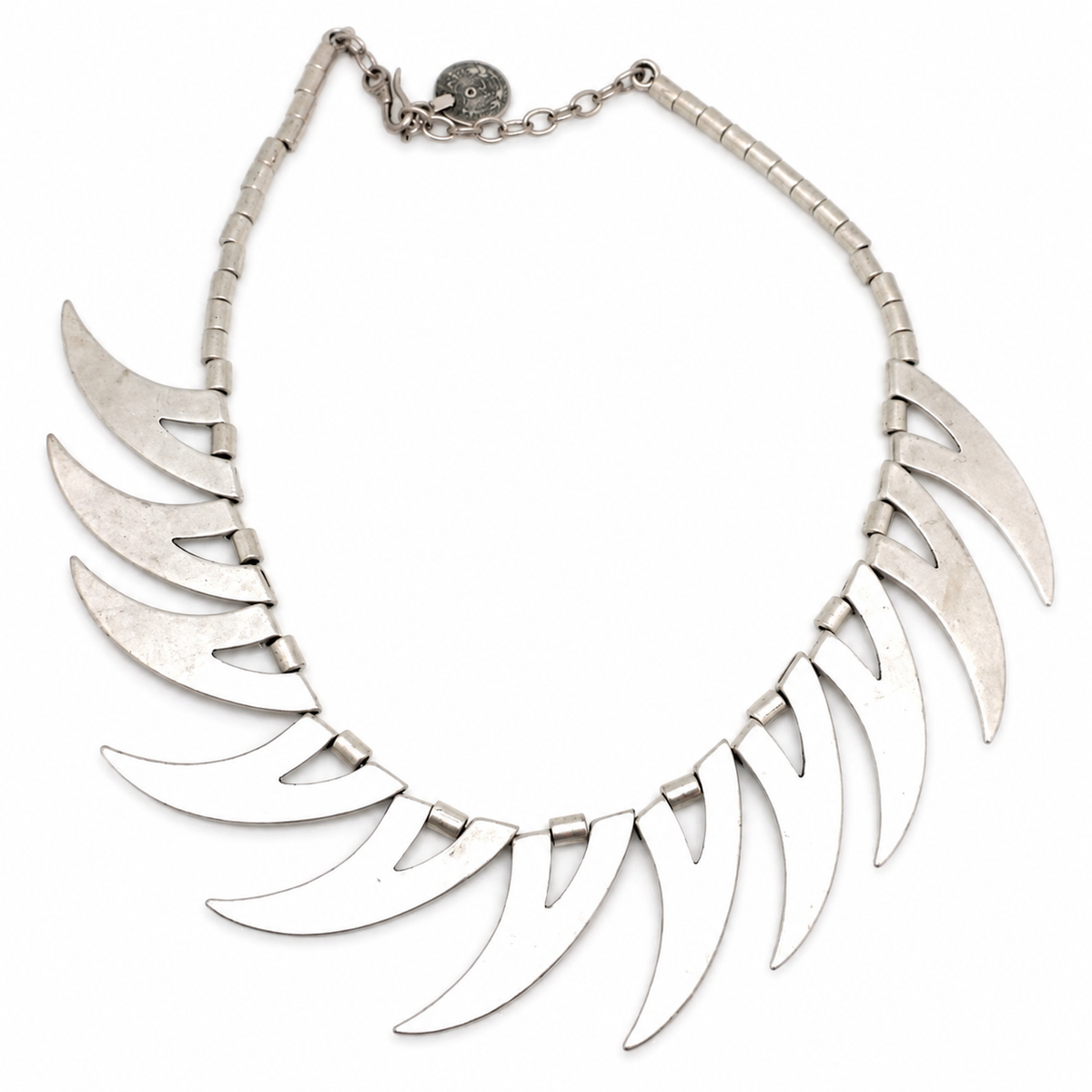Silver-tone collar necklace with curved crescent spike shapes.