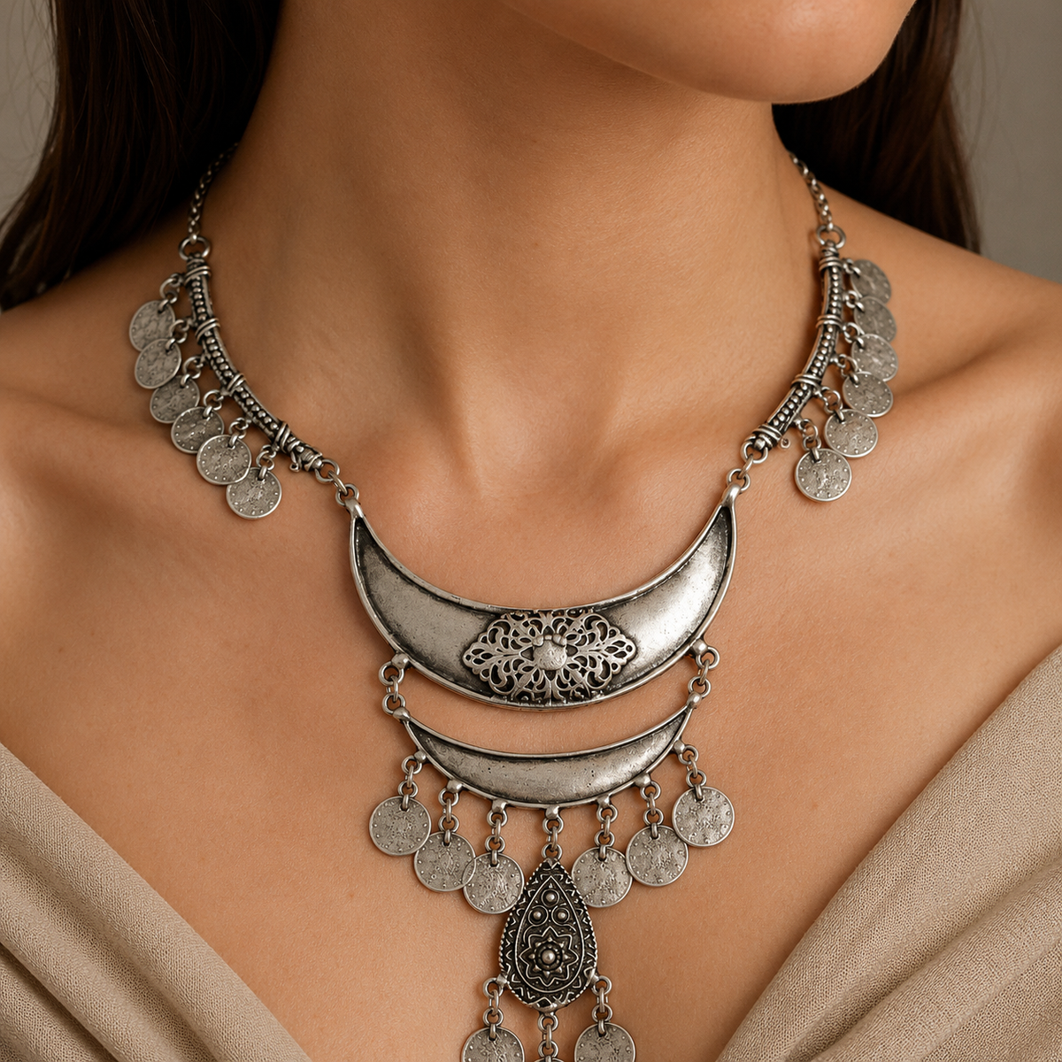 Silver-tone bib necklace shown from the front with layered coin fringe.