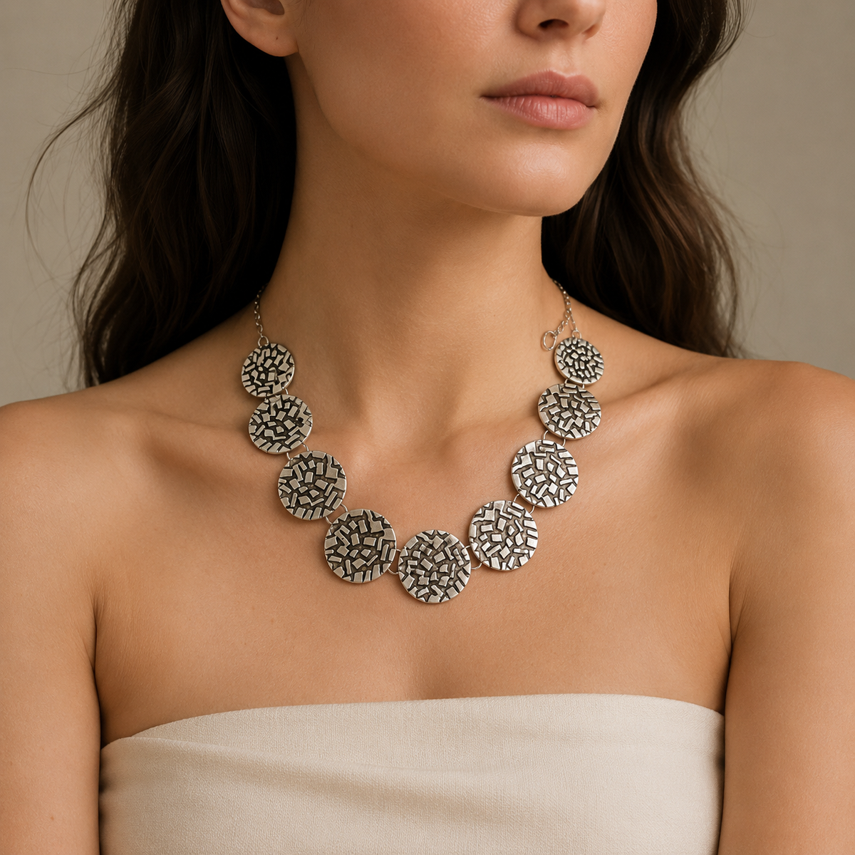 Silver round disc necklace with a bold sculptural silhouette.