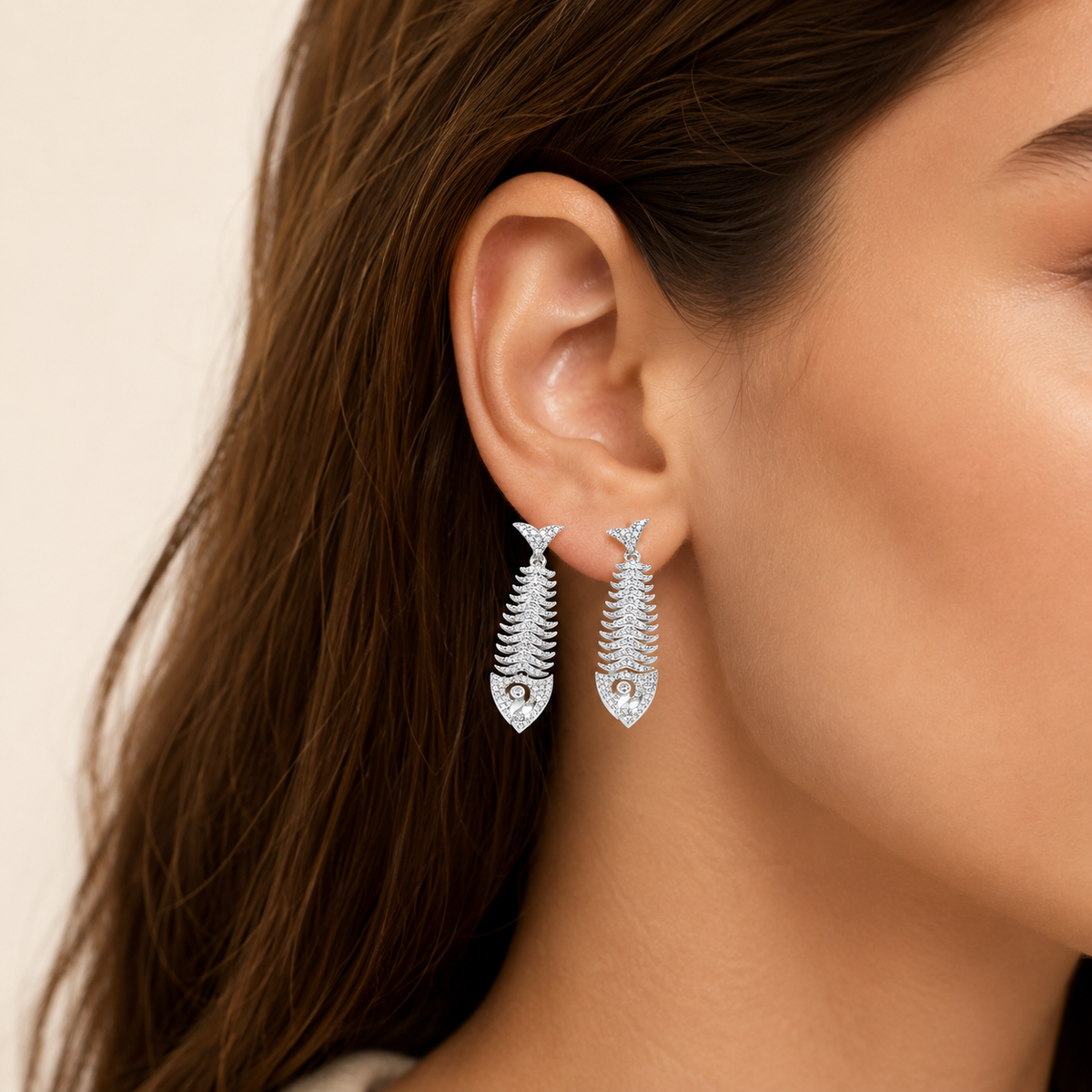 Silver fish bone earrings with CZ accents shown on a clean white background.