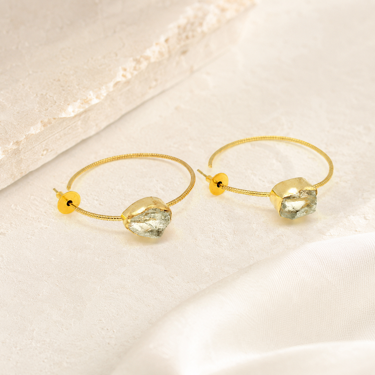 Yellow solar quartz earrings with a polished gold-plated hook design.