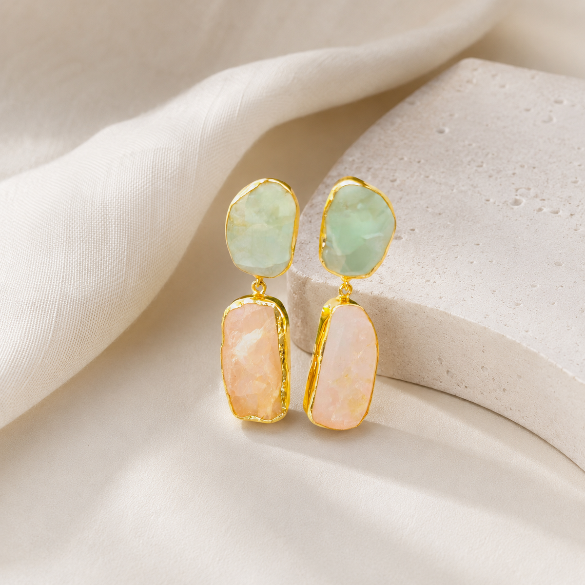 Gold-tone drop earrings with organic stone shapes.