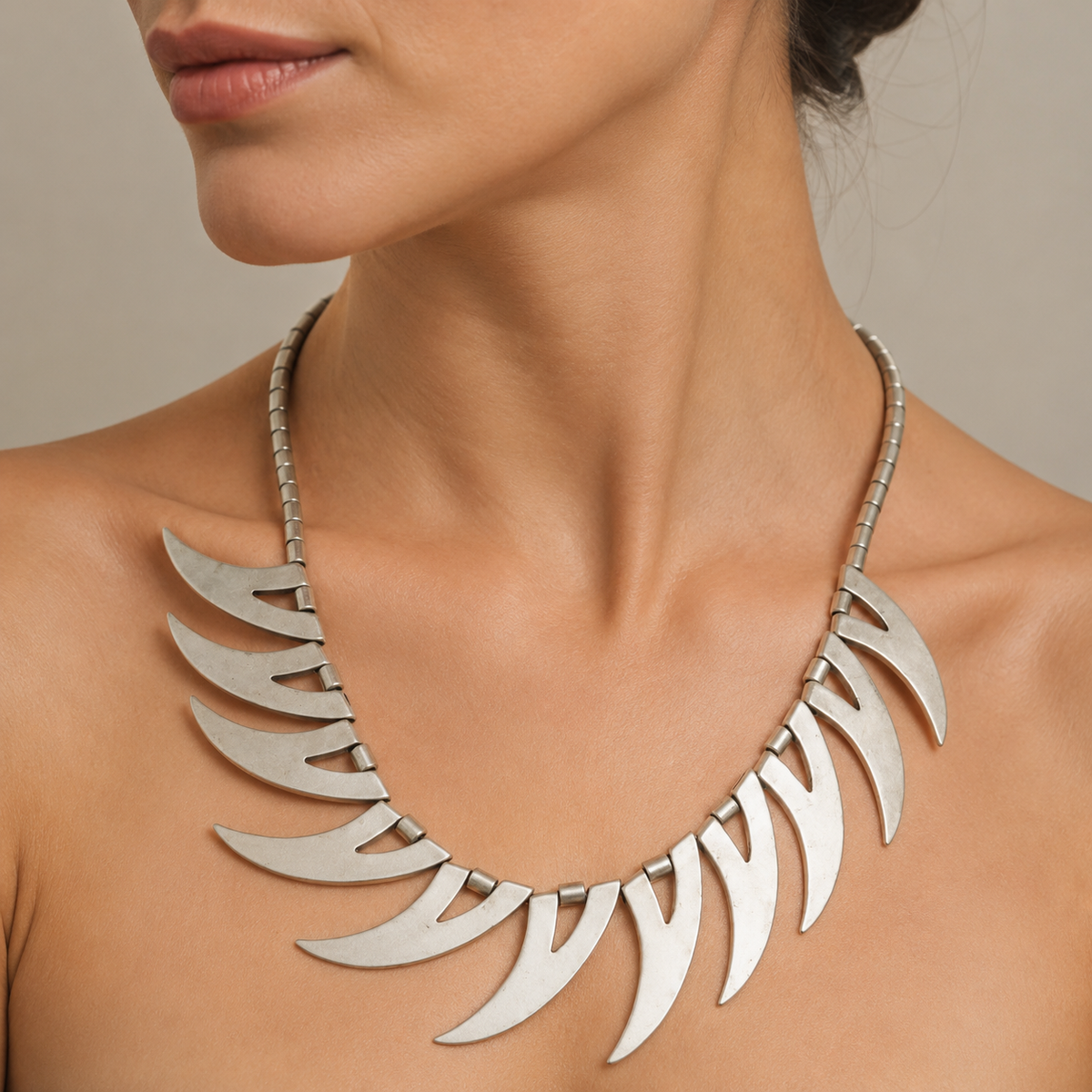 Silver-tone crescent spike collar necklace shown on a white background.