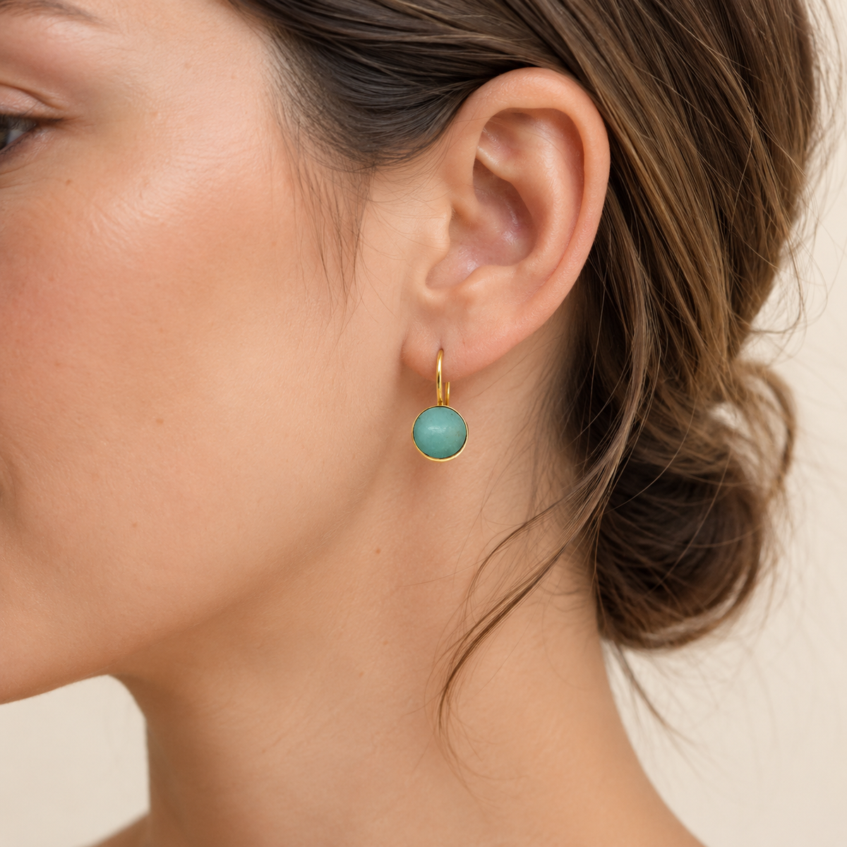 Pair of clear quartz drop earrings with a polished gold-plated setting.