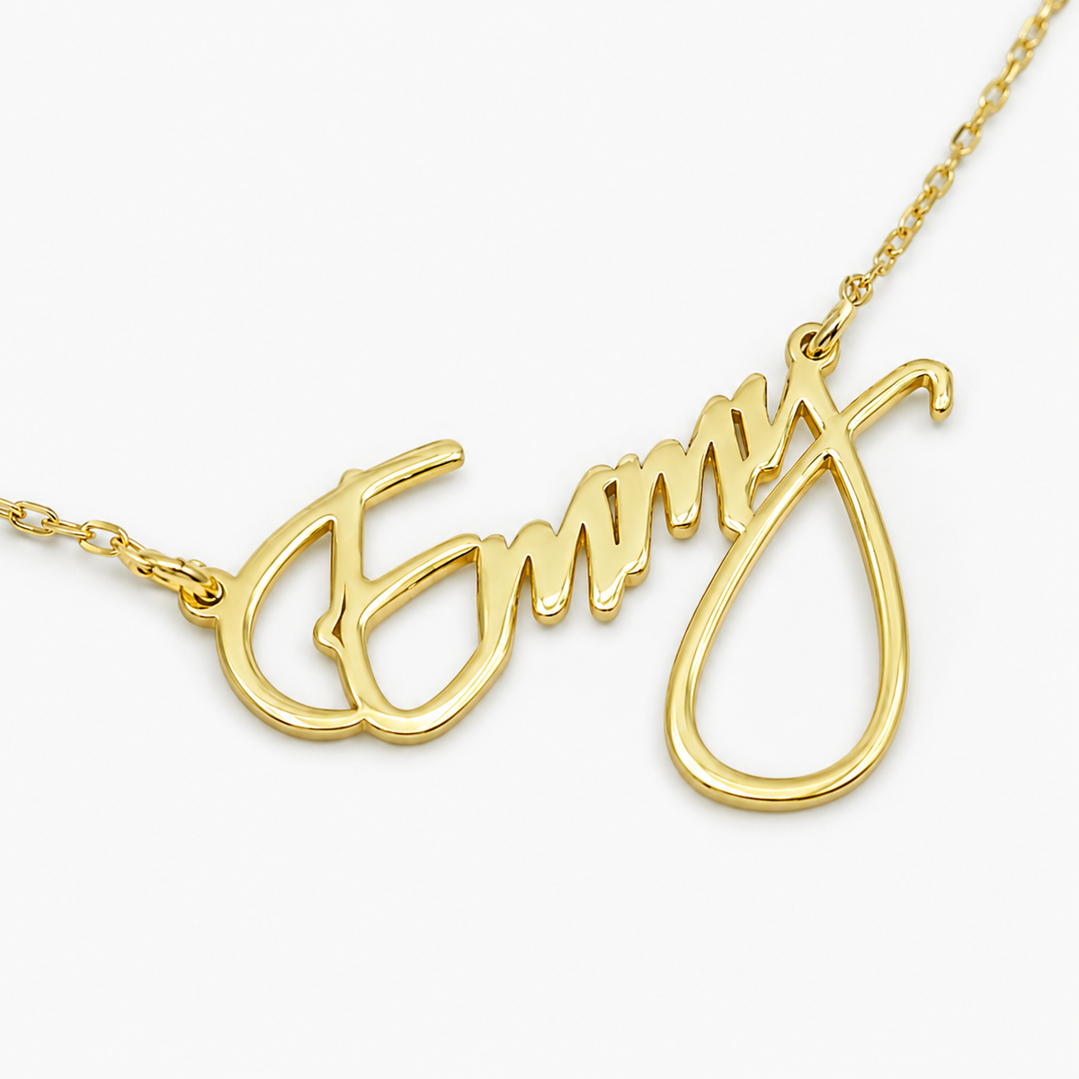 Close view of the script name pendant in a gold-tone finish.