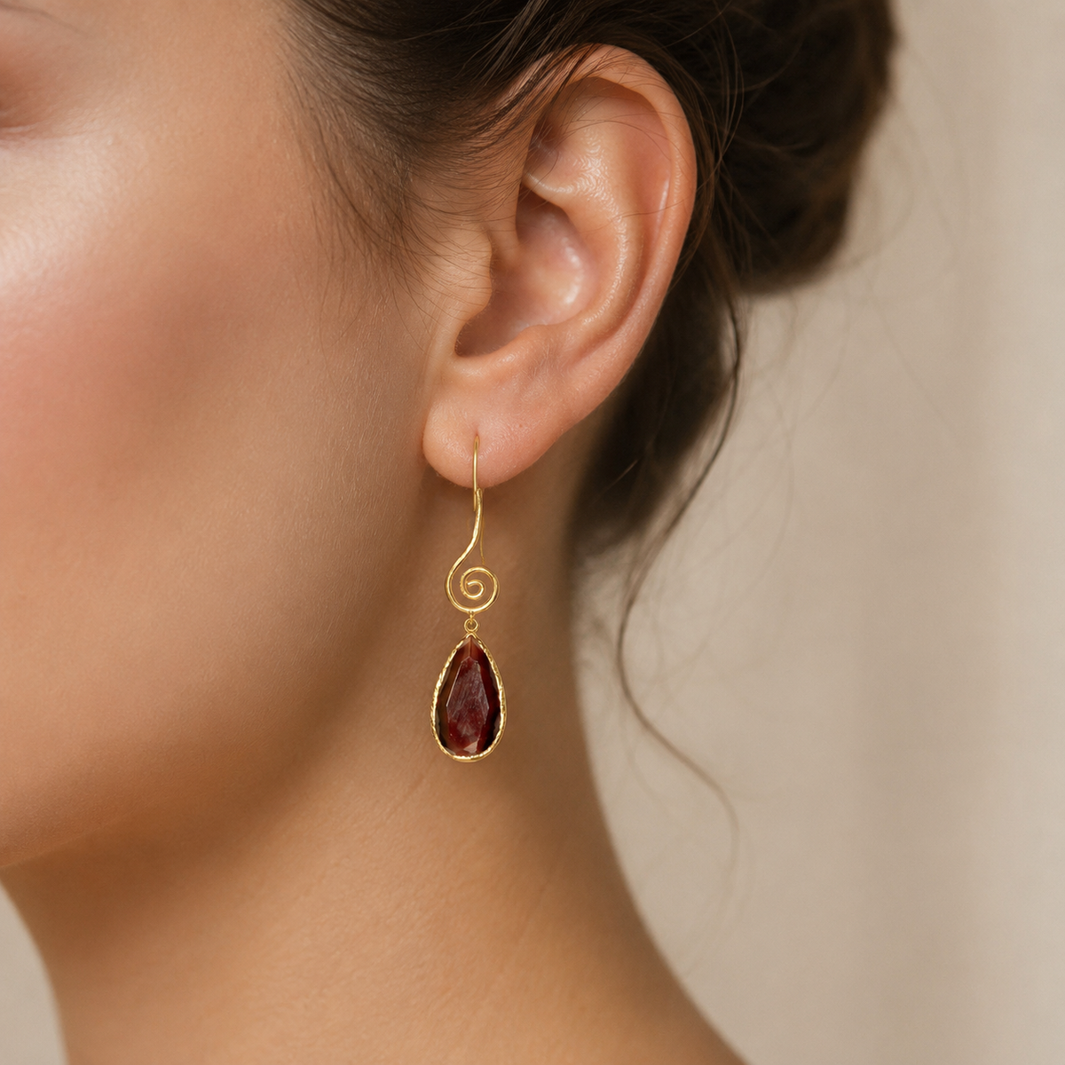 Gold-plated spiral drop earrings with brown teardrop stones.