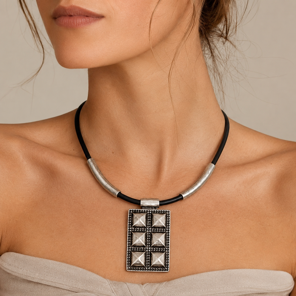 Black cord geometric pendant necklace shown front view with silver-tone details.