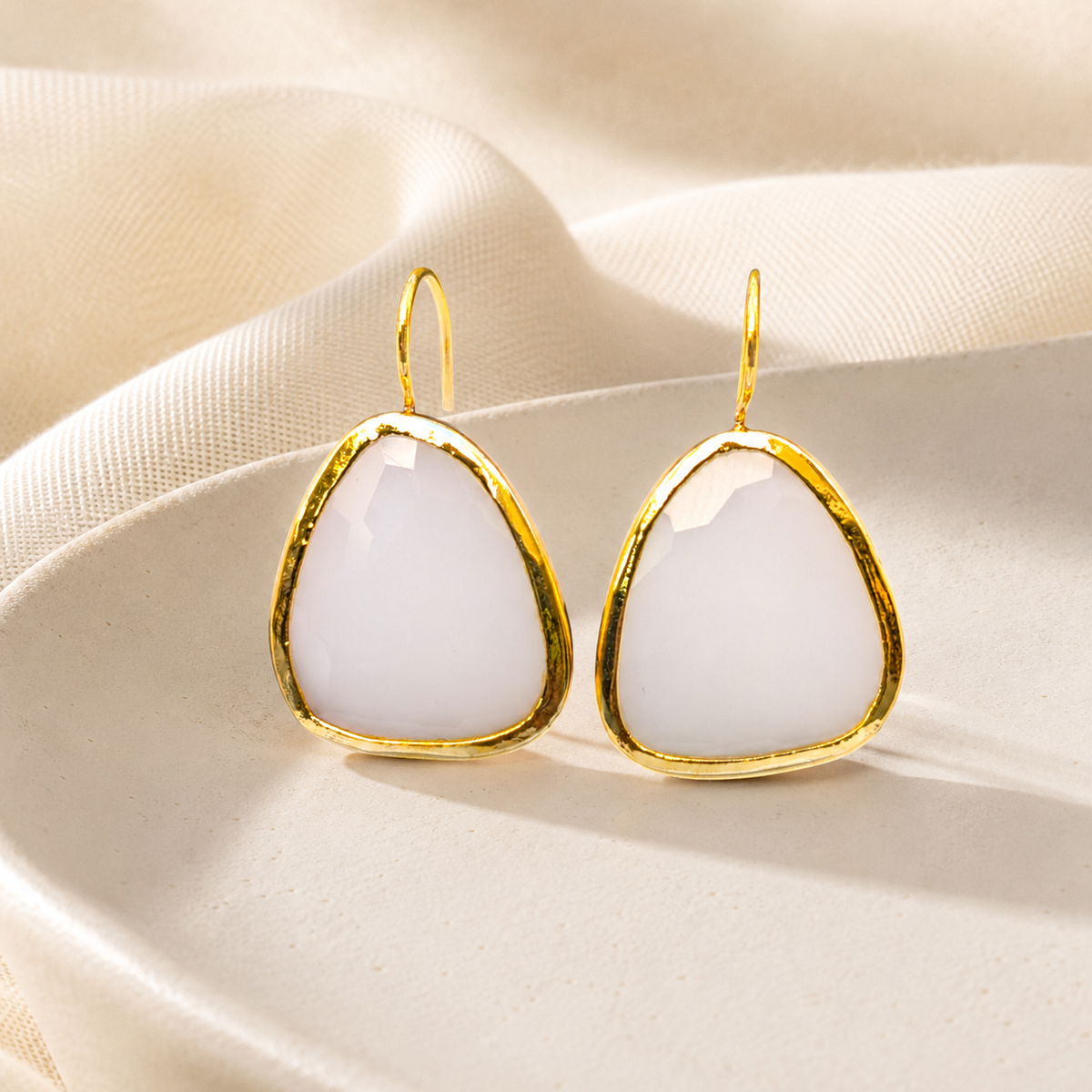 White chalcedony drop earrings with a soft organic shape and gold-plated finish.