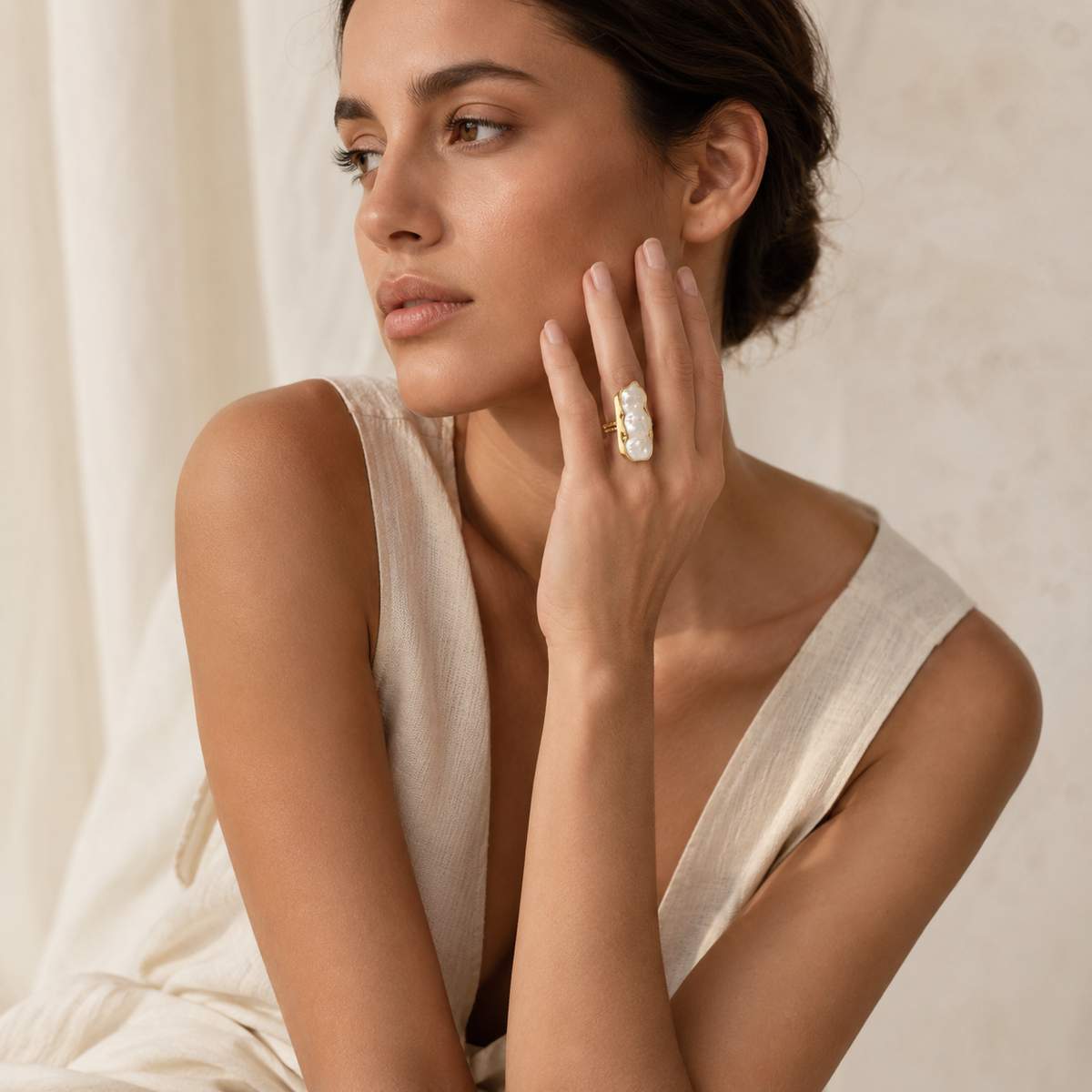 A sculptural baroque pearl ring in a warm gold-plated finish.