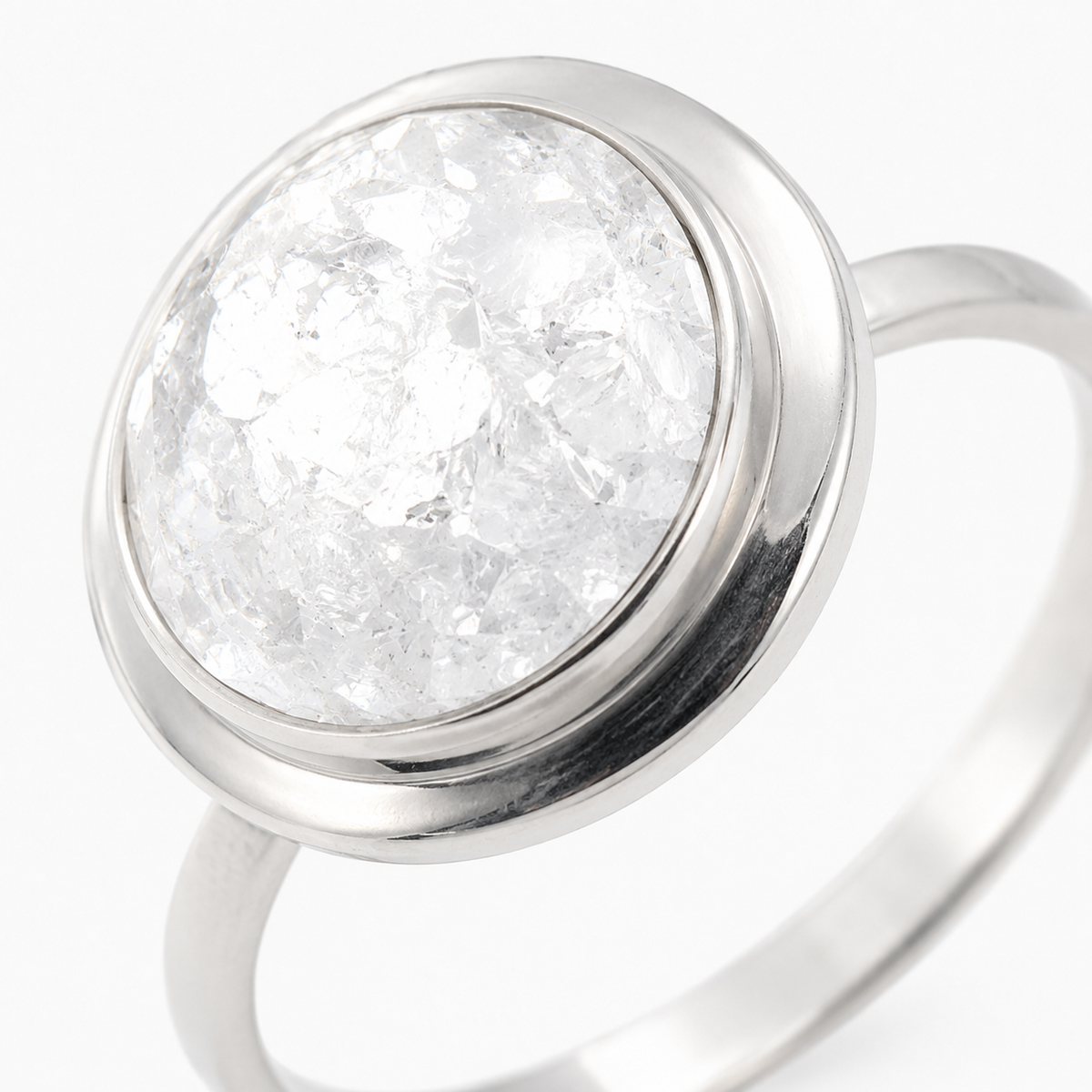 Close view of a round clear quartz-inspired stone in a smooth bezel setting.