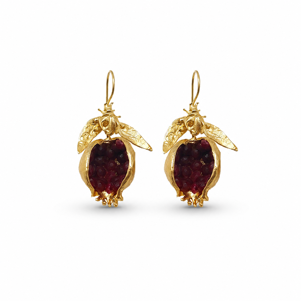 Pair of gold-plated drop earrings with pomegranate-red stones.