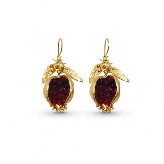Pair of gold-plated drop earrings with pomegranate-red stones.