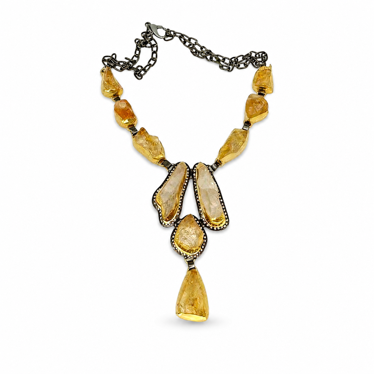 Raw citrine statement necklace with a gold-tone setting and dark chain.