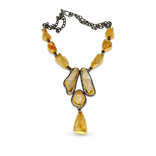 Raw citrine statement necklace with a gold-tone setting and dark chain.