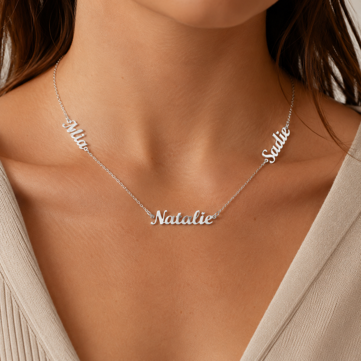 Silver-tone personalized necklace with three name charms shown front view.