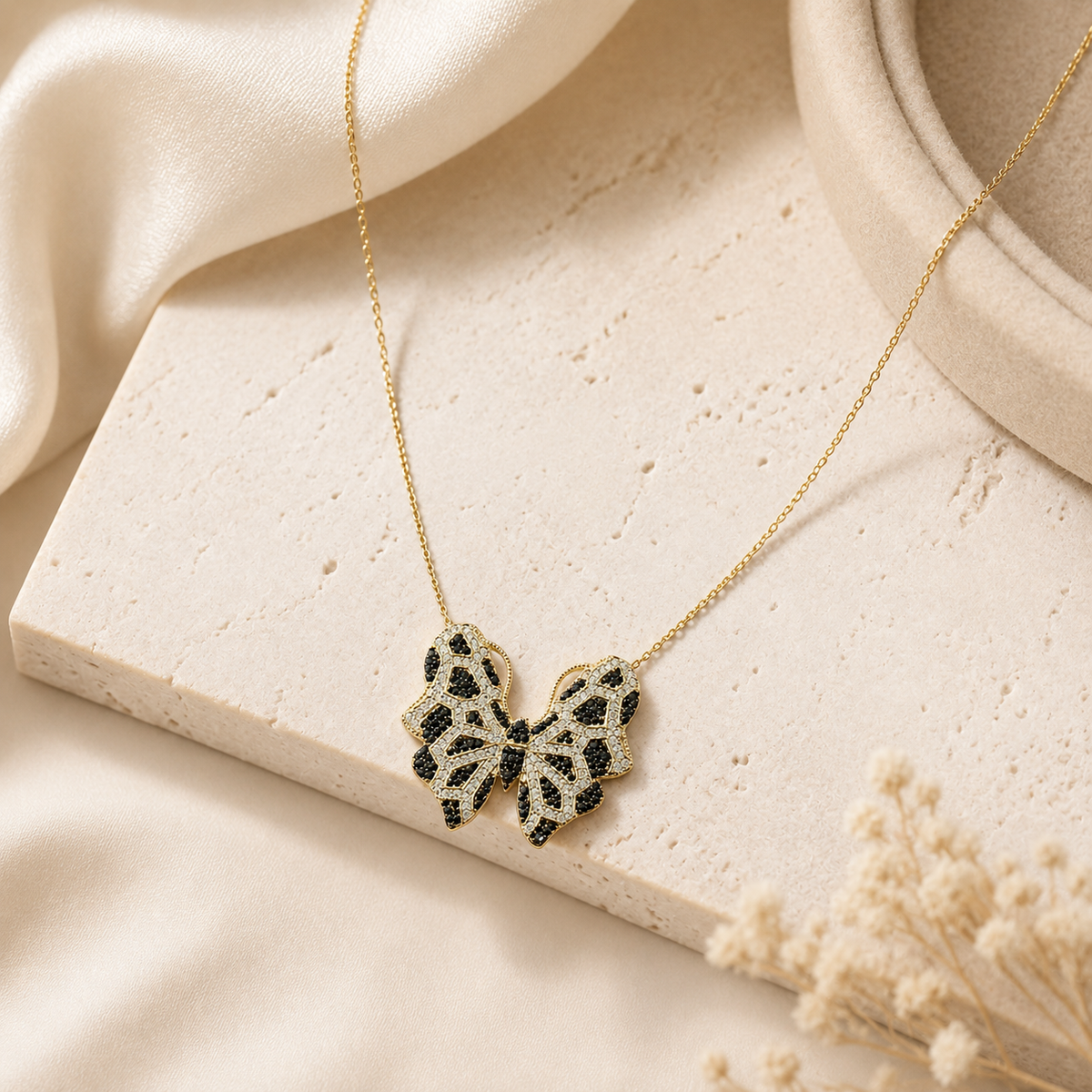 Gold-tone necklace featuring a butterfly pendant with multicolor CZ accents.
