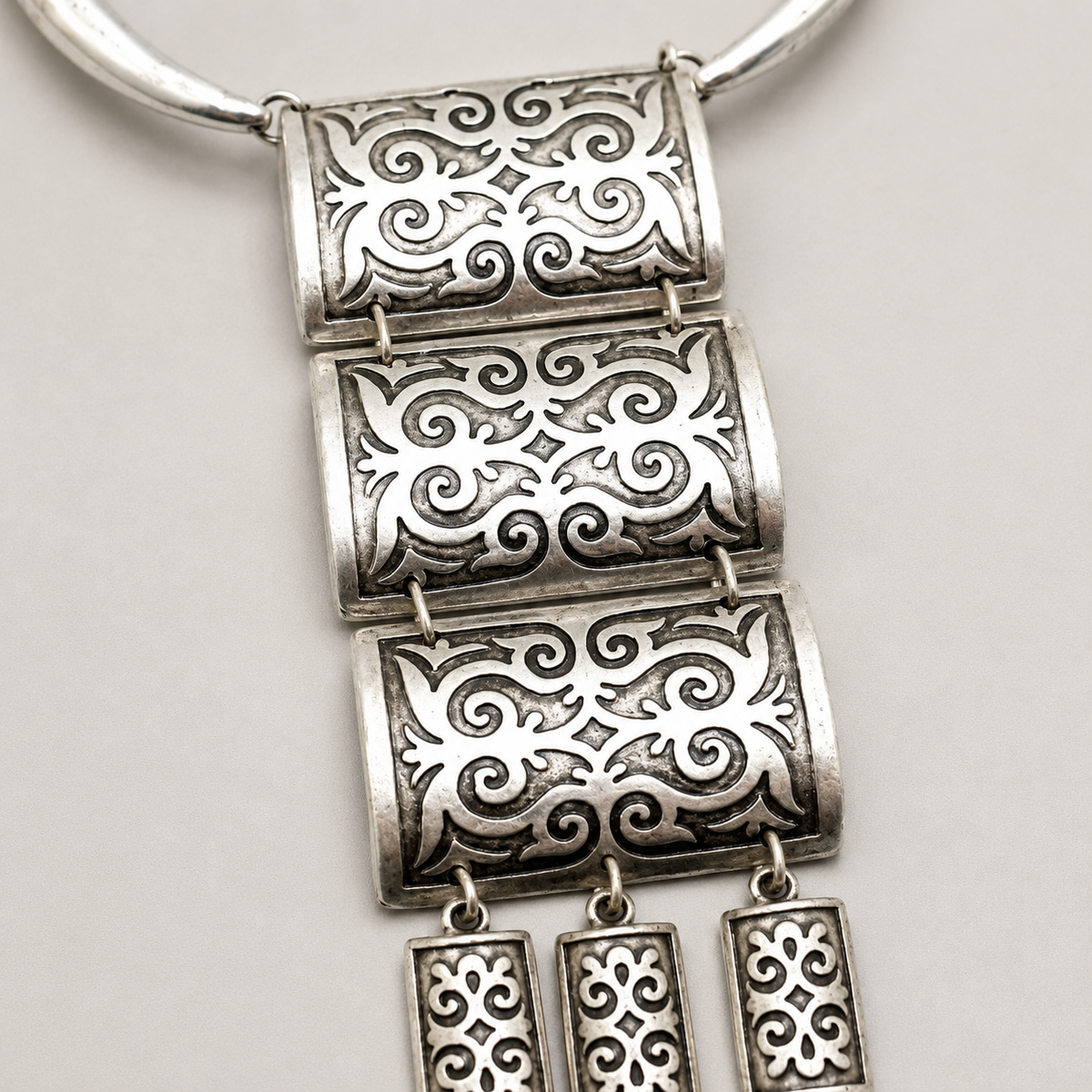 Close view of the black enamel-inspired detailing on the pendant panels.